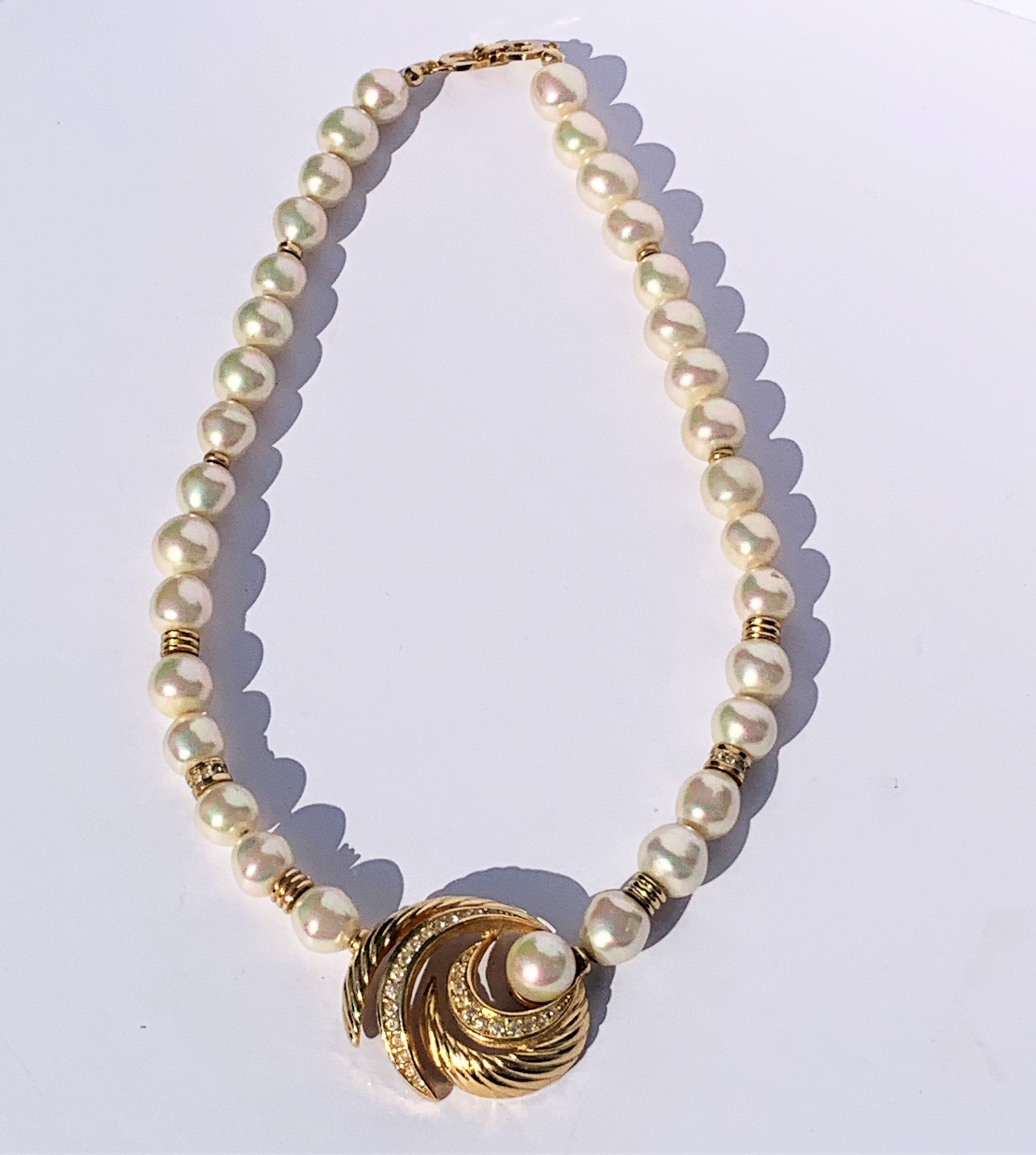Costume pearl and gold plated swirl necklace