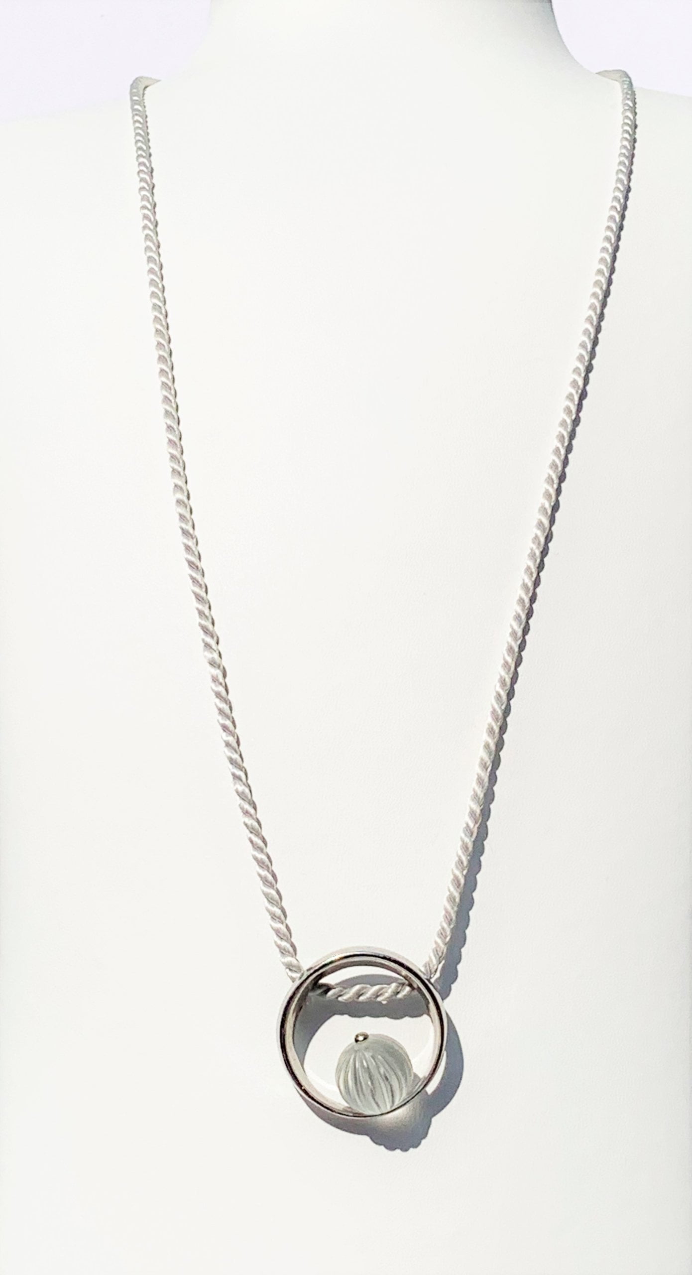 lalique circle pendant with clear bead on a grey silk chain