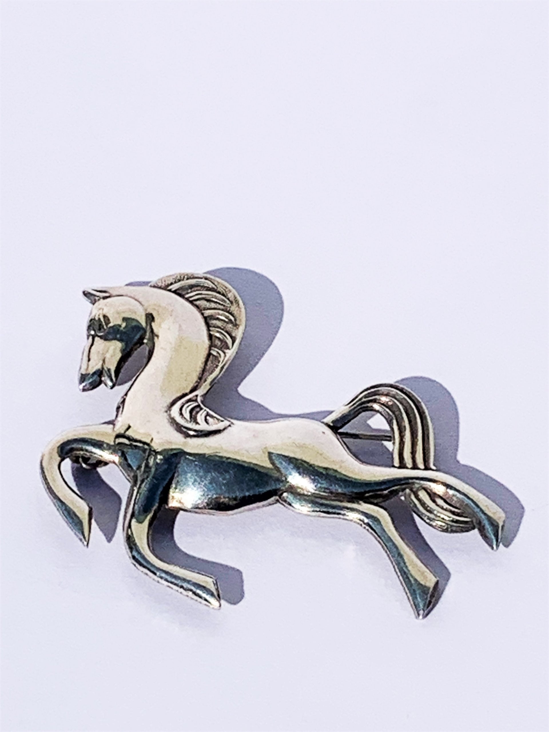 Leaping horse brooch marked Silver on the reverse.